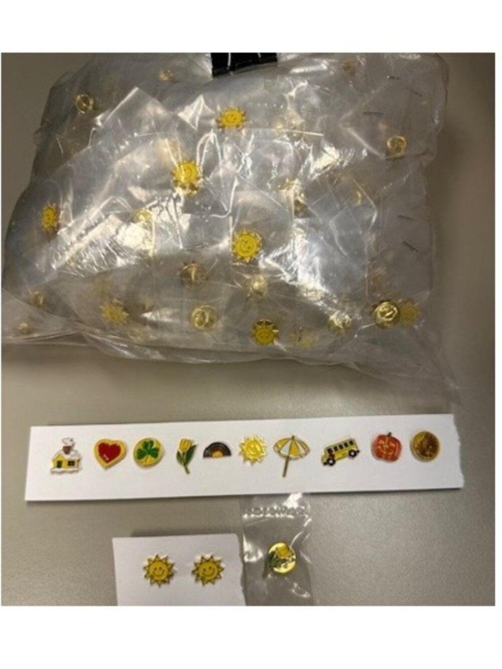 Approx. 230 individually bagged smiley face lapel pins with WR on each of them